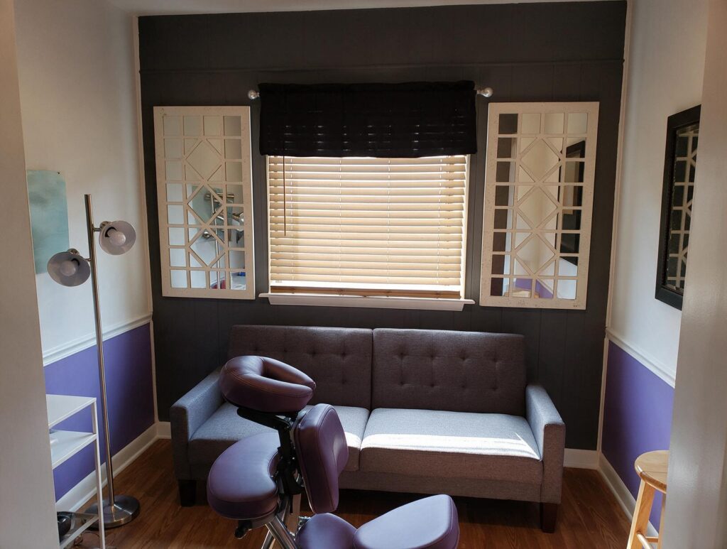 3659 featured 1792469566: carolina scalp center Empty treatment room with a gray sofa, purple massage chair, two white lattice mirrors